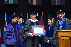 Ralph Munro receives his degree